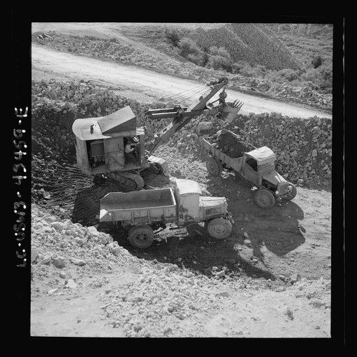 Untitled photo, possibly related to: New Idria, California. Trucks, shovel, and crane used in loading cinnabar, an ore containing mercury, at an open-cut mine of the New Idria Quicksilver Mining Company's workings