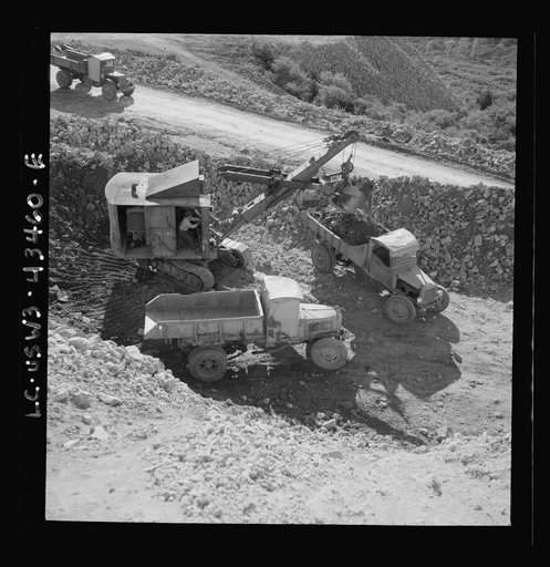 Untitled photo, possibly related to: New Idria, California. Trucks, shovel, and crane used in loading cinnabar, an ore containing mercury, at an open-cut mine of the New Idria Quicksilver Mining Company's workings
