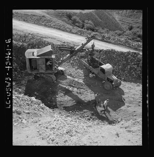 Untitled photo, possibly related to: New Idria, California. Trucks, shovel, and crane used in loading cinnabar, an ore containing mercury, at an open-cut mine of the New Idria Quicksilver Mining Company's workings
