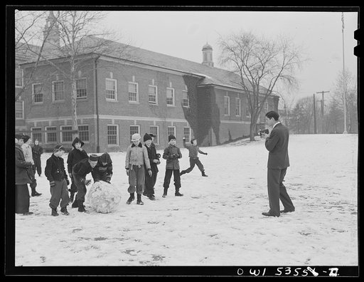Wilmington, Delaware. Tower Hill School, noted country day school for pupils from three to eighteen years of age. Children making a snowball during recess, while a teacher(?) takes their picture