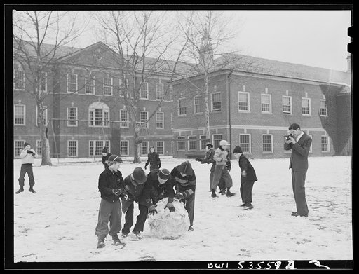 Wilmington, Delaware. Tower Hill School, noted country day school for pupils from three to eighteen years of age. Children making a snowball during recess, while a teacher(?) takes their picture