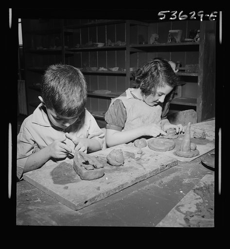 New York, New York. Two children of working mothers, developing their favorite hobbies during after school hours at Greenwich houses where they receive day care until the mothers call for them