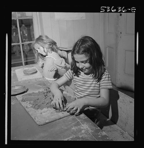New York, New York. Two children of working mothers who receive day care at Greenwich House enjoying their work in clay. They also enjoy singing and dancing and rest in after school hours at this neighborhood center