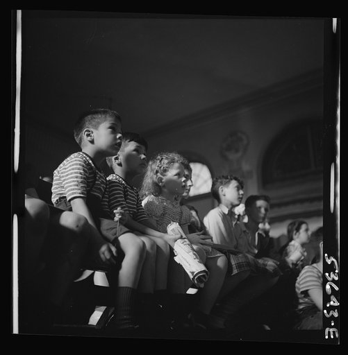 New York, New York. Children engrossed by a play put on by playmates at Greenwich House where they receive day care after school hours and on Saturdays while their mothers are working