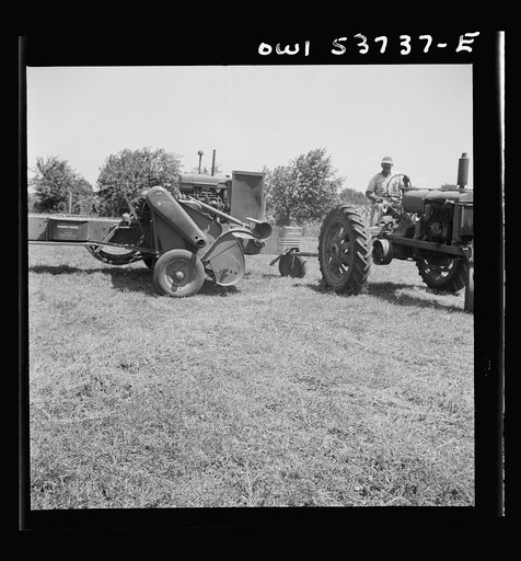 Untitled photo, possibly related to: Dresher, Pennsylvania. Detail of baling machine showing hay being picked up at the Spring Run Farm