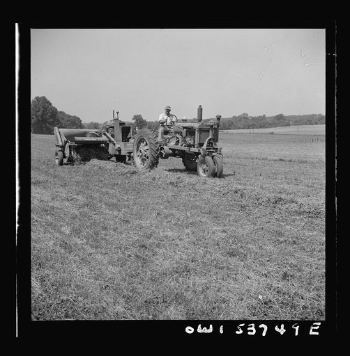 Dresher, Pennsylvania. Operating a hay baling machine at the Spring Run Farm
