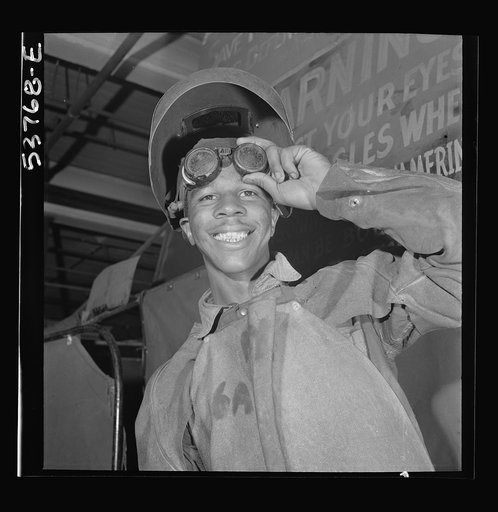 NYA (National Youth Administration) work center, Brooklyn, New York. A Negro who is receiving training in machine shop practice shown in his welder's outfit