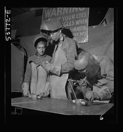 NYA (National Youth Administration) work center, Brooklyn, New York. Two Negro welders, who are receiving their training in machine shop practice, building up an undersize shaft by arc welding to be re-machined to size