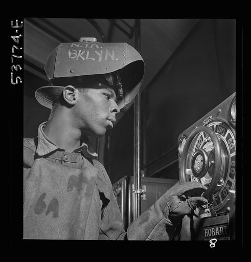 NYA (National Youth Administration) work center, Brooklyn, New York. A Negro, who is receiving training in arc welding, adjusting the output of a motor generator set
