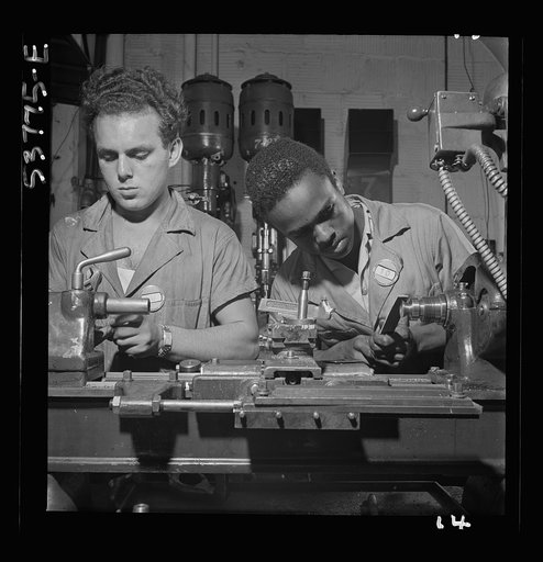 NYA (National Youth Administration) work center, Brooklyn, New York. Two bench-lathe workers, who are receiving training in machine shop practice, removing burrs from special taper head screws