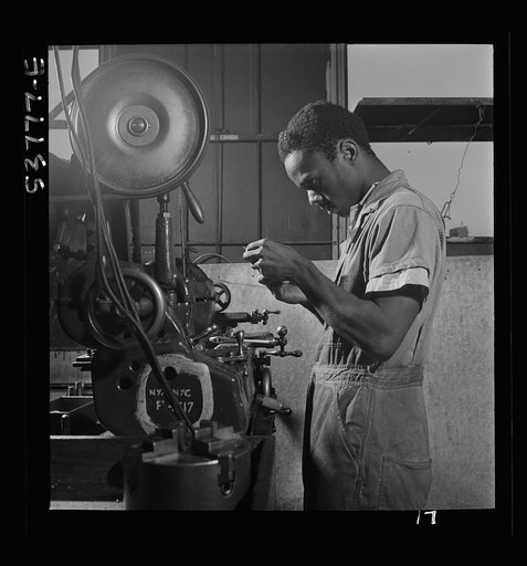 NYA (National Youth Administration) work center, Brooklyn, New York. A Negro turret-lathe worker, who is receiving training in machine shop practice, learning a filing operation on a turret lathe