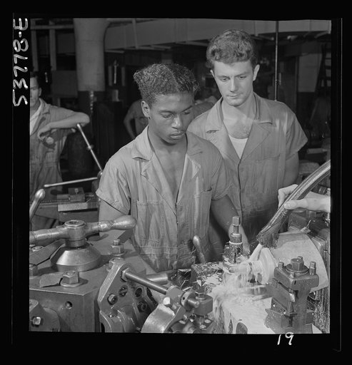 NYA (National Youth Administration) work center, Brooklyn, New York. A Negro bench-lathe worker, who is receiving training in machine shop practice, gauging a screw just removed from the collet