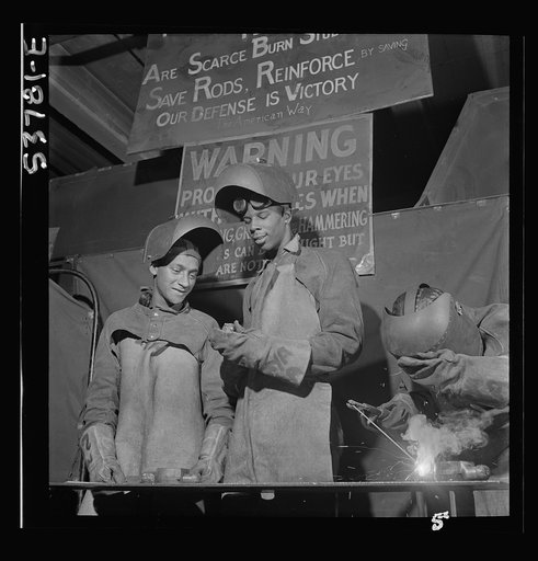 NYA (National Youth Administration) work center, Brooklyn, New York. Two welders, who are receiving training in machine shop practice, building up an undersize shaft by arc welding to be re-machined to size