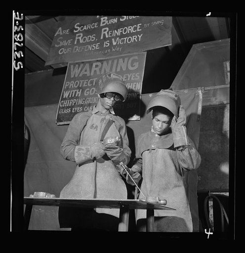 NYA (National Youth Administration) work center, Brooklyn, New York. Two welders, who are receiving training in machine shop practice, building up an undersize shaft by arc welding to be re-machined to size
