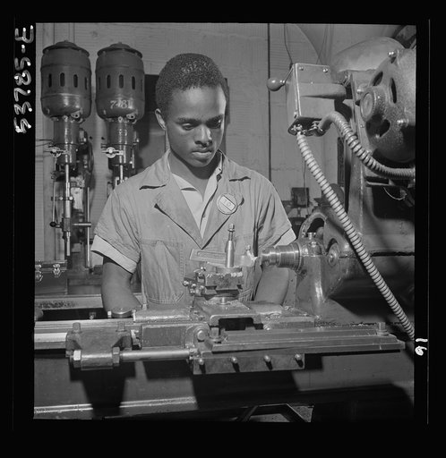 NYA (National Youth Administration) work center, Brooklyn, New York. A Negro bench-lathe worker, who is receiving training in machine shop practice, removing burrs from a special taper head screw
