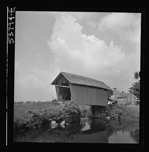 The Orton home and barn, Marshfield, Vermont as seen from across the Winooski River, showing a covered bridge in the foreground