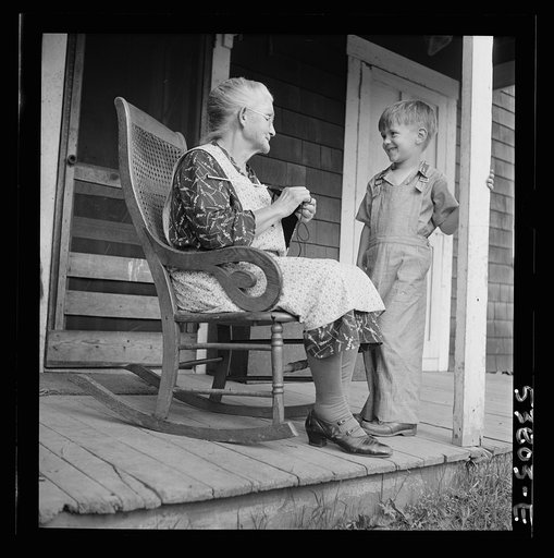 East Montpelier, Vermont. Charles Ormsbee's widowed mother, Mrs. Myrtle Ormsbee, knitting sweaters for the Red Cross, and entertaining her grandson of five at the same time