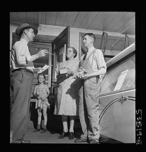 West Danville, Vermont. OPA (Office of Price Administration) inspector Maurice J. Sullivan stopping in for a friendly visit with the Hastings. He mentions that chickens and strawberries don't have to have their calling prices posted because they are not designated as cost of living commodities in Bu