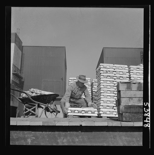 Las Vegas, Nevada. Enormous asbestos mittens are worn by the worker handling the hot magnesium ingots produced at the Basic Magnesium Incorporated plant in the southern Nevada desert