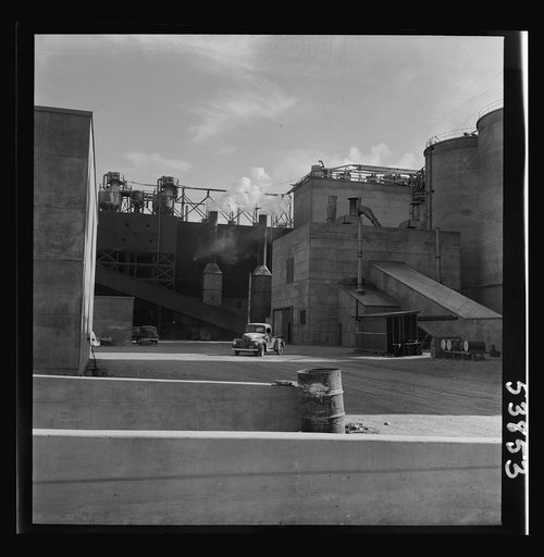 Las Vegas, Nevada. A rear view of some of the structures of the Basic Magnesium Incorporated plant, showing at the far right of the picture two of the eighty-four foot silos used for the storage of ore. Great quantities of the lightest of all metals are produced at this plant for aircraft and other 