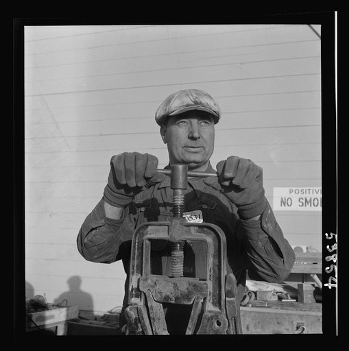 Las Vegas, Nevada. One of the construction workers at the Basic Magnesium Incorporated plant, working at the pipe vise. He is working on a building near the peat storage building shown in the background