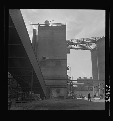 Las Vegas, Nevada. A scene in the Basic Magnesium Incorporated grounds, showing a variety of structures and at the far right of the picture, two of the eighty-four foot silos in which ore is stored for use in the production of magnesium, the lightest of all metals used in aircraft and other wartime 