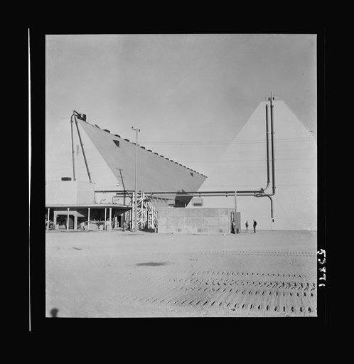Las Vegas, Nevada. Two peat storage buildings, 540 by 100 feet, on the Basic Magnesium Incorporated grounds in the southern Nevada desert, which produces great quantities of the lightest of all metals for aircraft manufacture