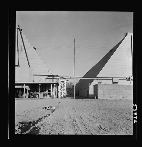 Las Vegas, Nevada. Two peat storage buildings, 540 by 100 feet, on the Basic Magnesium Incorporated grounds in the southern Nevada desert, which produces great quantities of the lightest of all metals for aircraft manufacture