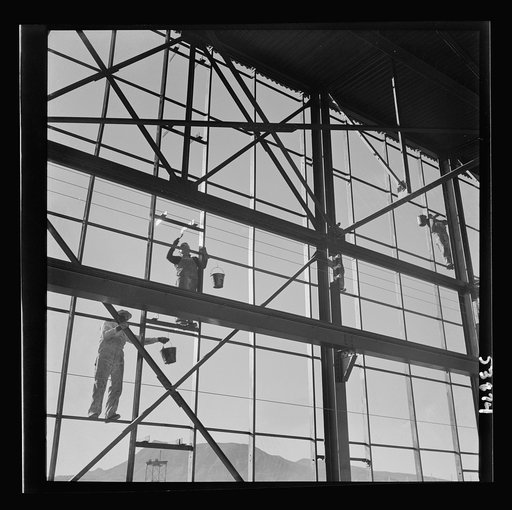 Las Vegas, Nevada. Painters at work seventy feet above ground on the gigantic construction of the Basic Magnesium Incorporated plant in the southern Nevada desert. A tower of another building and mountain tops can be seen in the background