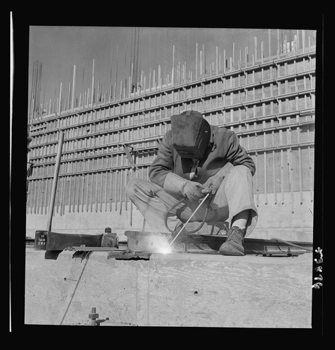Las Vegas, Nevada. A helmeted welder busy in his part in the completion of the Basic Magnesium Incorporated plant in the southern Nevada desert, which will turn out great quantities of this lightest of all metals for aircraft and tracer bullet manufacturers