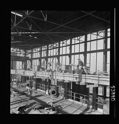 Las Vegas, Nevada. A construction scene inside one of the huge buildings of the Basic Magnesium Incorporated plant in the southern Nevada desert. Workmen are busy with the steel structure and carpenter work