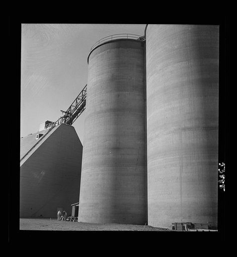 Las Vegas, Nevada. Giant silos, eighty-four feet high, for the storage of ore for the manufacture of magnesium at the Basic Magnesium Incorporated plant in the southern Nevada desert. A peat storage building can be seen at the left