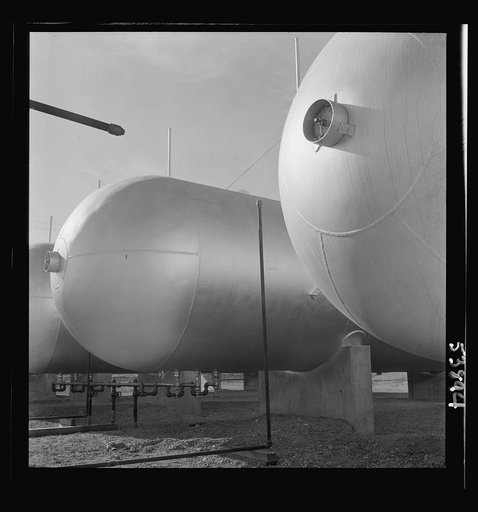 Las Vegas, Nevada. Like a row of dirigible balloons, the propane gas storage tanks rest upon the floor of the southern Nevada desert at Basic Magnesium's giant plant, where magnesium is produced