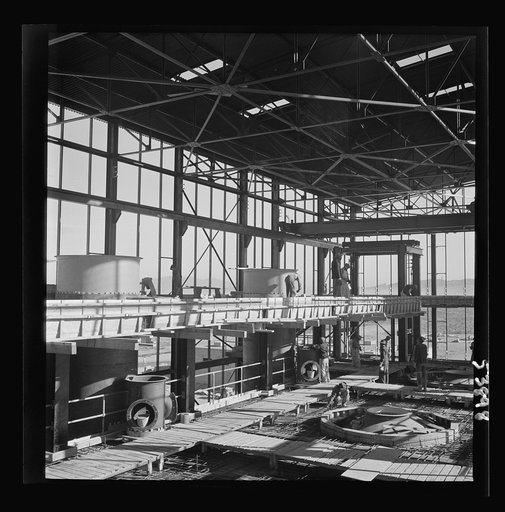 Untitled photo, possibly related to: Las Vegas, Nevada. A construction scene at the Basic Magnesium Incorporated plant in the southern Nevada desert, showing workmen engaged in the steel structure of one of the chlorination plants