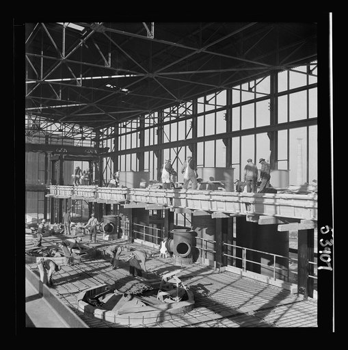 Untitled photo, possibly related to: Las Vegas, Nevada. A construction scene inside one of the huge buildings of the Basic Magnesium Incorporated plant in the southern Nevada desert. Workmen are busy with the steel structure and carpenter work