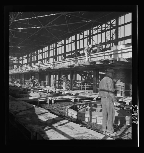 Untitled photo, possibly related to: Las Vegas, Nevada. A construction scene at the Basic Magnesium Incorporated plant in the southern Nevada desert, showing workmen engaged in the steel structure of one of the chlorination plants