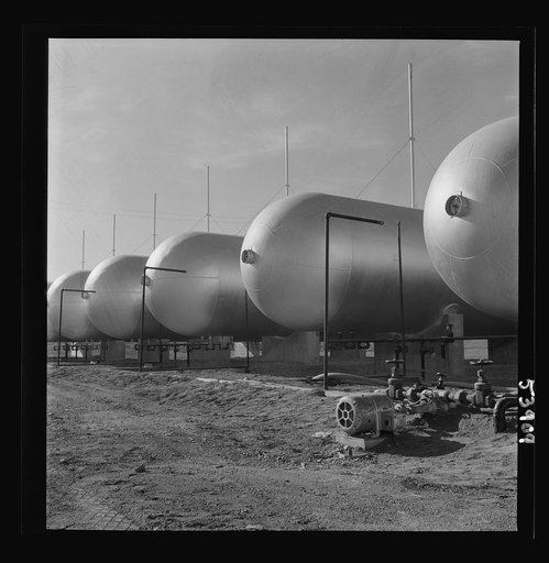 Untitled photo, possibly related to: Las Vegas, Nevada. Like a row of dirigible balloons, the propane gas storage tanks rest upon the floor of the southern Nevada desert at Basic Magnesium's giant plant, where magnesium is produced