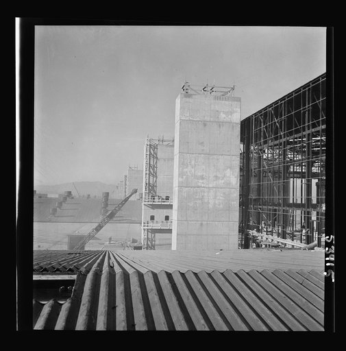 Untitled photo, possibly related to: Las Vegas, Nevada. Some completed and also some unfinished buildings of the Basic Magnesium Incorporated plant. The building at the far right of the picture is still in the steel structure stage