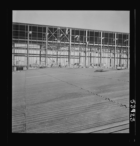 Untitled photo, possibly related to: Las Vegas, Nevada. Some completed and also some unfinished buildings of the Basic Magnesium Incorporated plant. The building at the far right of the picture is still in the steel structure stage