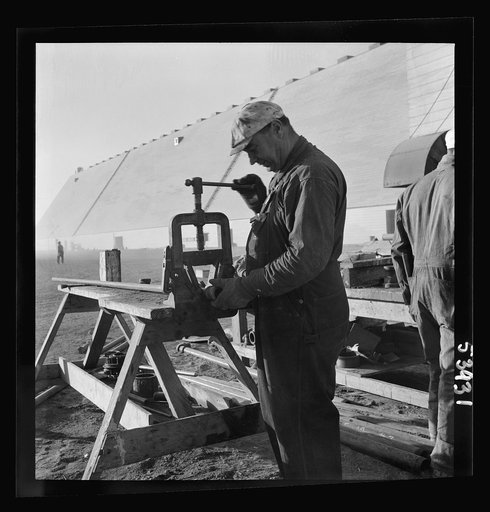 Untitled photo, possibly related to: Las Vegas, Nevada. Giant silos, eighty-four feet high, for the storage of ore for the manufacture of magnesium, and a peat-storage building on the grounds of Basic Magnesium Incorporated