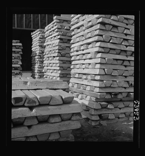 Untitled photo, possibly related to: Las Vegas, Nevada. Stacks of magnesium ingots ready for war use by manufacturers of aircraft and tracer bullets, produced by the Basic Magnesium Incorporated plant in the southern Nevada desert