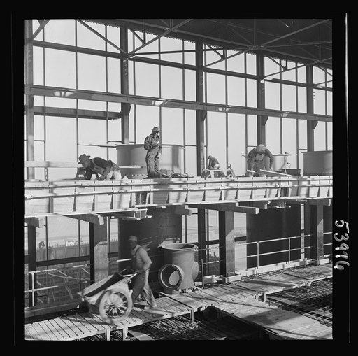 Untitled photo, possibly related to: Las Vegas, Nevada. A construction scene at the Basic Magnesium Incorporated plant in the southern Nevada desert, showing workmen engaged in the steel structure of one of the chlorination plants