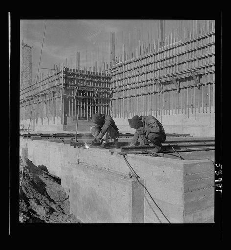 Untitled photo, possibly related to: Las Vegas, Nevada. Helmeted welders busy in their part in the completion of the Basic Magnesium plant in the southern Nevada desert, which will turn out great quantities of this lightest of all metals for aircraft and tracer bullet manufacturers