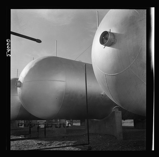Untitled photo, possibly related to: Las Vegas, Nevada. Like a row of dirigible balloons, the propane gas storage tanks rest upon the floor of the southern Nevada desert at Basic Magnesium's giant plant, where magnesium is produced