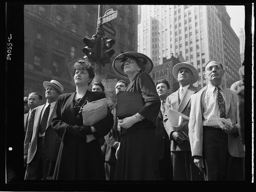 New York, New York. A crowd watching the news line on the Times building at Times Square