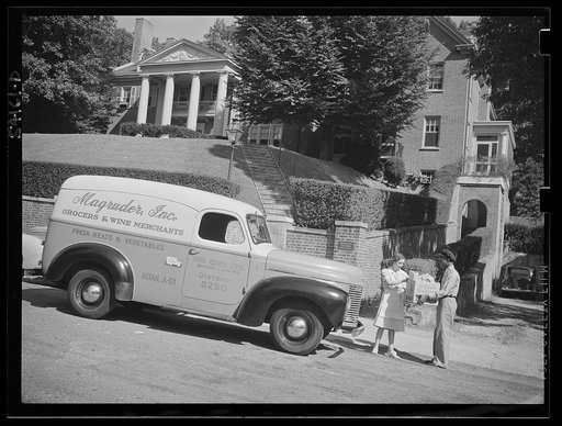 Washington, D.C. A Magruder, Inc. grocery truck showing its United States Truck Conservation Corps pledge in front of a home where the driver is handing a box of groceries to a housewife