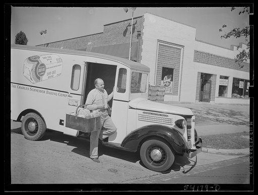 Washington, D.C. A Charles Schneider Baking Company delivery truck displaying a United States Truck Conservation Corps pledge, showing a driver alighting with a basket of bread