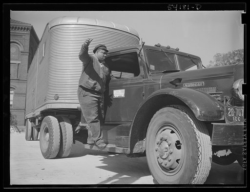 Washington, D.C. An autocar long distance hauling van, showing a United States Truck Conservation Corps pledge on the door. The driver, standing on the running board, is apparently directing someone in front of it