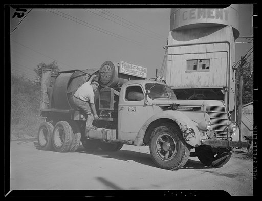 Untitled photo, possibly related to: Washington, D.C. A commercial truck with the driver standing at the door of it where there is displayed a United States Truck Conservation Corps pledge