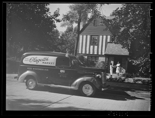 Untitled photo, possibly related to: Washington, D.C. A Clagett Market delivery truck displaying a United States Truck Conservation Corps pledge standing in front of a residence where the driver is handing a basket of groceries to a colored maid